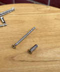 8 Set M4 X 60mm Breakaway Phillips Flat Countersunk Screws With Posts on wooden surface