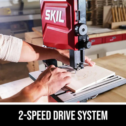 Person using 2.8 Amp 9 Inch Benchtop Band Saw for Woodworking, 2-Speed Drive, cutting wood in a workshop setting.