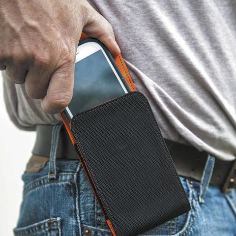 Person using Phone Holder With Magnetic Closure And Belt Clip For iPhone Google LG And Samsung on hip, made from durable 1680D nylon.