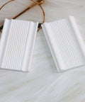 2mm Polymer Clay Micro Bead Roller Tool For Tiny Round Beads, white finish, showing two textured white bead rollers on marble surface