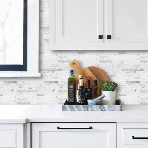 Faux Stone Peel And Stick Backsplash Tiles 20 Sheets White Marble Look PVC Wall Tiles For Kitchen shown behind counter items.