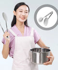 Woman holding stainless steel frying tongs and pot, kitchen use