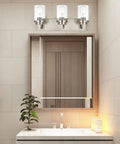 Three Light Vanity Light Fixture In Brushed Nickel With Clear Glass Shades For Modern Bathrooms above mirror setup