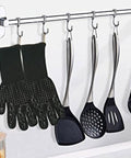 Heavy Duty BBQ Cooking Gloves For Outdoor Grilling And Camping, Heat Resistant hanging on a kitchen rack with utensils