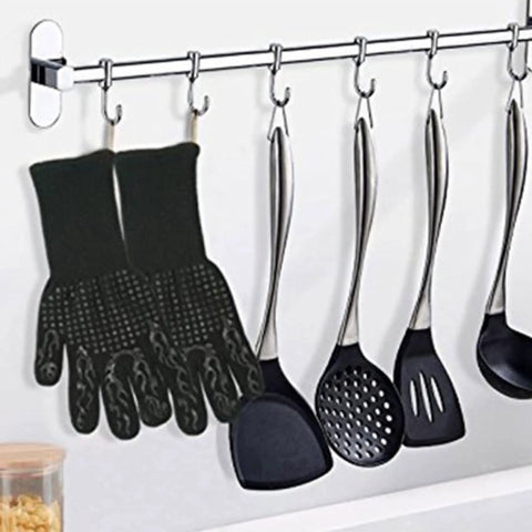 Heavy Duty BBQ Cooking Gloves For Outdoor Grilling And Camping, Heat Resistant hanging on a kitchen rack with utensils