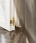 3 Way Adjustable Invisible Door Hinge Concealed Hidden 180 Degree Swing Zinc Alloy Matte Gold Butt Hinge installed on white door