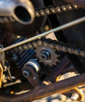 Solid Badass Weld On Motorcycle Chain Tensioner Compatible With 530 Sprockets For Custom Chopper Bobber And Cafe Racer Mods close-up showing chain and sprocket.