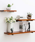 Decorative wooden shelves with heavy duty 8 inch black shelf brackets, holding books and vases, wall mounted display.