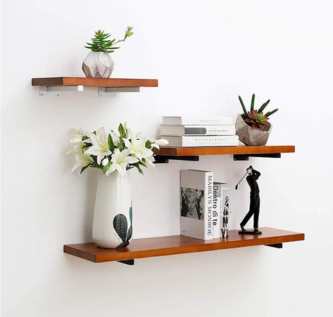 Decorative wooden shelves with heavy duty 8 inch black shelf brackets, holding books and vases, wall mounted display.