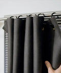 Ultra Slick Flexible Mass Loaded Vinyl Soundproofing Barrier Roll One Pound High Density Acoustic Insulation Sheet hanging on a curtain rod.
