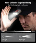 Man wearing clip on hat light with 500 lumen output ultra lightweight headlamp demonstrating hover to dim feature.