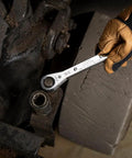 Gloved hand using Ratcheting Box Wrench Set SAE One Quarter Inch To Three Fourth Inch Five Piece Kit with ten sizes