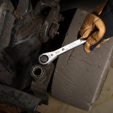 Gloved hand using Ratcheting Box Wrench Set SAE One Quarter Inch To Three Fourth Inch Five Piece Kit with ten sizes