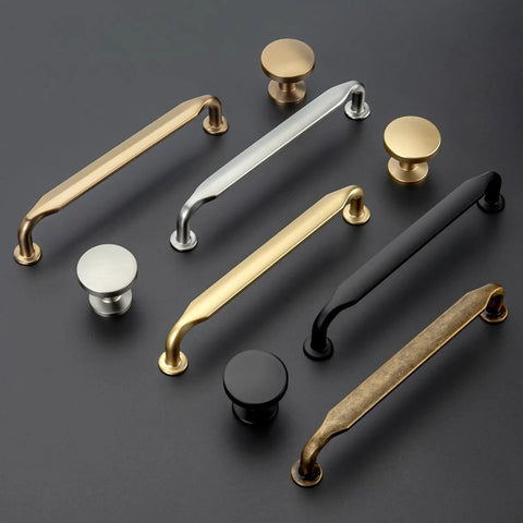 Assorted cabinet and drawer handles on display, including Ten Pack 5 Inch Antique Brass Cabinet Pulls For Kitchen Cabinets And Bathroom Vanities.