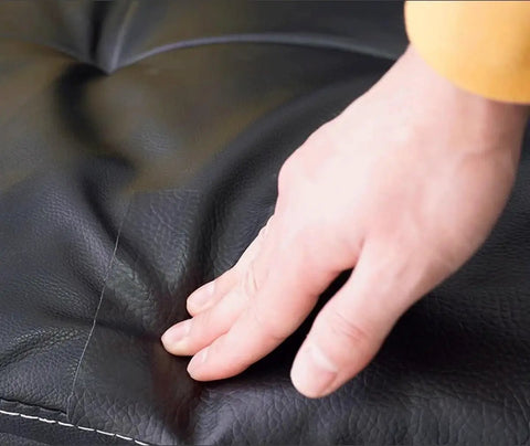 Hand applying Self Adhesive Leather Repair Patch 54x20 Inch Peel And Stick Easy Fix Leather Tape on black leather surface