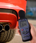 Person using Digital Sound Level Meter And Noise Logger For Work And Home, Measures 30 To 130 dBA With 1.5 dB Accuracy near car exhaust