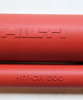 Close-up of Red Adhesive Cartridge Holder HIT-CR-500 showing logos, designed for HDM Manual Dispenser with secure heavy-duty clip.