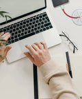2 Pack White Flexible Desk Cable Grommets With Soft Rubber Edges For Smooth Slinging Of Wires And Zero Clutter Vibe, used in a tidy workspace with a laptop.
