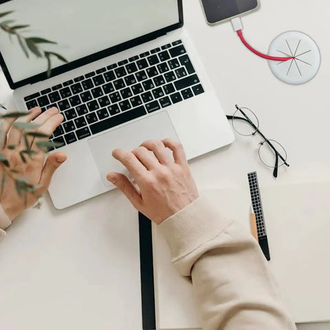 2 Pack White Flexible Desk Cable Grommets With Soft Rubber Edges For Smooth Slinging Of Wires And Zero Clutter Vibe, used in a tidy workspace with a laptop.
