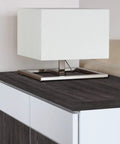 Lamp on a cabinet with Oak Schefield Dark Self Adhesive Vinyl Film 17 Inch By 78 Inch Roll Peel And Stick Decor for Cabinets.