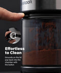 Hella Consistent Grind Flat Burr Coffee Bean Crusher With Thirty Two Precision Settings And Forty Second Auto Timer showing easy-clean feature with coffee grounds.