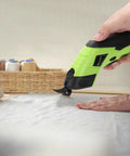 Cordless Electric Fabric Scissors With Rechargeable Power Shears in use cutting fabric, featuring solid grip and ergonomic design.
