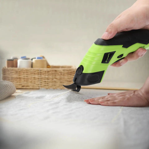 Cordless Electric Fabric Scissors With Rechargeable Power Shears in use cutting fabric, featuring solid grip and ergonomic design.