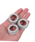 No Fuss 3/4 Inch Plastic Insulating Bushings 100 Pack, three gray plastic bushings in a hand for weatherproof electrical fittings.