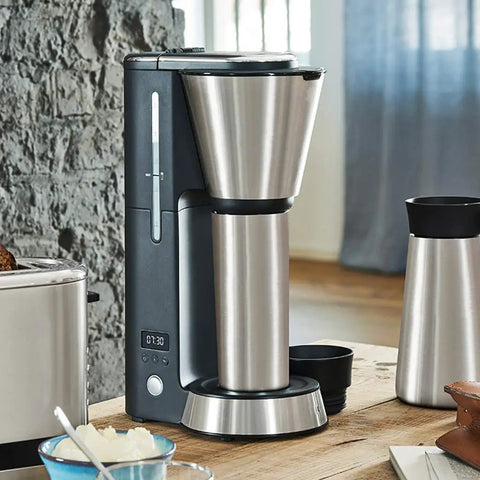 Fully Automatic Bean To Cup Coffee Maker With Integrated Milk Steam Wand, sleek stainless steel design on wooden countertop.