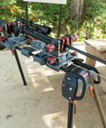 Deluxe Carbon Fiber Cleaning Rod For .27 to .45 Caliber Rifles displayed on gun maintenance stand outdoors.