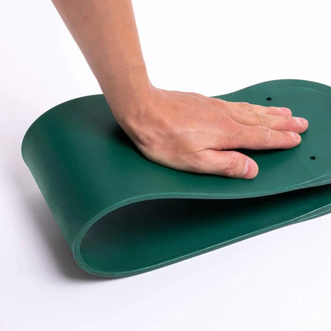 Close-up of hand pressing green EVA seat from 2 Pack Heavy Duty Kids Swing Seat Set With 66 Inch Chain Plastic Coated For Outdoor Playground Replacement Includes Safety Snap Hooks And EVA Seats That Supports Up To 250 Lbs Backyard Ready.