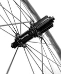 Close-up of Carbon Wheelset 700C Tubeless Road Wheels With Wave Rim 45mm 50mm Depth, V Brake Compatible hub and spokes.