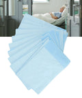 Hella Soft Disposable Bed Pads For Adults Heavy Absorbent Underpad With Odor Blocking Fluff Pulp Super Gentle On Skin Top Pick For Maternity Recovery Baby Changing And Sweet Dreams 10 Pack Large stacked and ready for use in a hospital room.