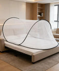 Large Pop Up Mosquito Tent For Adults on bed, white mesh, portable foldable net for camping, fits one person, quick set up.