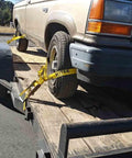4 Pack Beefed Up Heavy Duty 2 Inch By 10 Foot Wheel Straps With Flat Hooks Lasso Style Tire Tie Downs securing vehicle