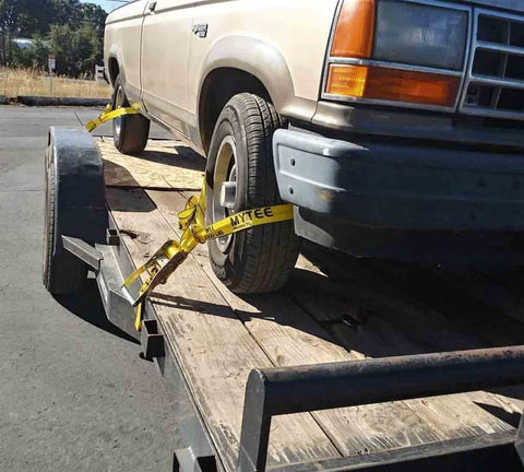 4 Pack Beefed Up Heavy Duty 2 Inch By 10 Foot Wheel Straps With Flat Hooks Lasso Style Tire Tie Downs securing vehicle