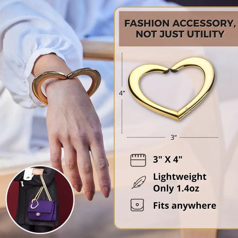 Gold Finish 22K Purse Hook For Table, Heart Shaped Portable Handbag Holder For Desk Travel Cafe And Office displayed on wrist