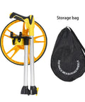12 Inch Folding Mechanical Measuring Wheel Straight Up Reliable Metric Distance Tracker With Portable Carry Handle top view with folded design and storage bag.
