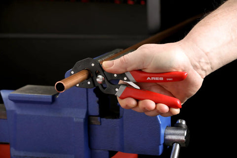2-Piece Self-Adjusting V-Notch Pliers Set 7-Inch And 10-Inch With Big Jaw Openings gripping a pipe in a vice