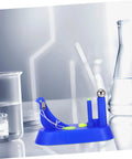 Hands On Newton Pendulum Inertia Demonstrator Kit for Classroom Physics Lab placed on a reflective surface with lab equipment