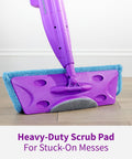 Close-up of Click N Clean Multi Surface Spray Mop with heavy-duty scrub pad showing on wood floor for tough cleaning tasks.