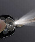 Ultra Compact Stick On LED Thumb Light attached to a key emitting bright light, water-resistant, easy peel and stick installation.