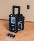 18V LXT Cordless Bluetooth Job Site Radio with FM Stereo Clock and Snooze Menu Controls on wooden surface