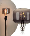 Amber Diamond Globe LED Edison Bulb 2200K Warm Glow, 4W Dimmable on a lamp displaying its champagne finish