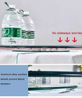 Go-To Heavy-Duty Glass Lazy Susan Turntable for Dining Tables with auxiliary wheels for stability, showing side view with water bottles