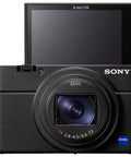 Front view of RX100 VII Premium Compact Camera Bundle With Pro Features On The Go Includes Triple Battery Pack, 64GB Card, Travel Case, Accessory Kit And Photo Video Software For Travel, Vlogging And Everyday Shooting