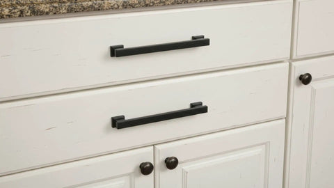 Matte black cabinet pulls on white drawers, 5-inch hole centers, part of 20 Pack Slick Matte Black Cabinet Pulls AL3061MB Durable Build
