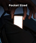 Pocket Sized Pro Grade Bicolor Panel Mini LED Light For DSLRs being taken out of a backpack pocket, illustrating portability.