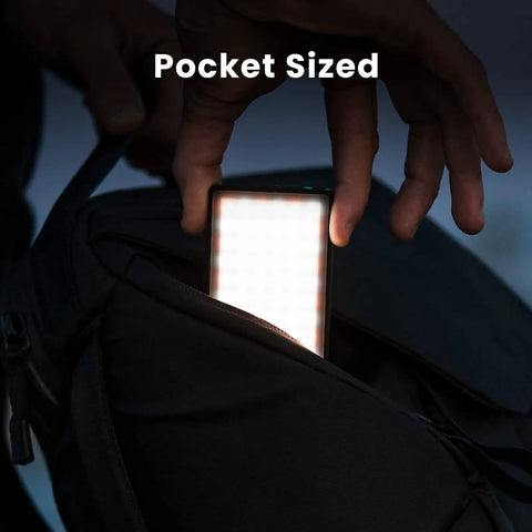 Pocket Sized Pro Grade Bicolor Panel Mini LED Light For DSLRs being taken out of a backpack pocket, illustrating portability.