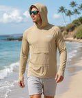 Man wearing Men's Ice Cool Silky Sun Protection Hoodie UPF 50 Plus Long Sleeve Rash Guard Shirt, sandy beach background